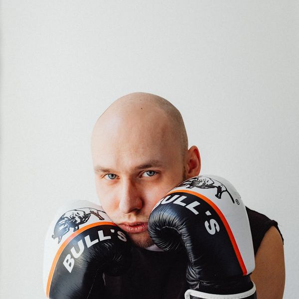 Man in a powerful warrior yoga pose, looking focused and strong.